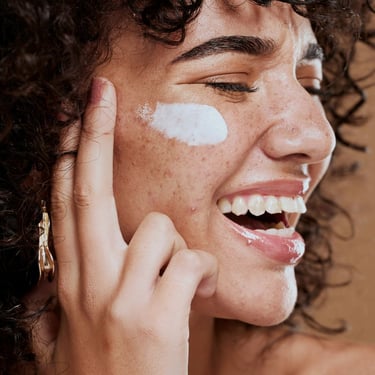 a woman with a white face and a white face with a white spot on her