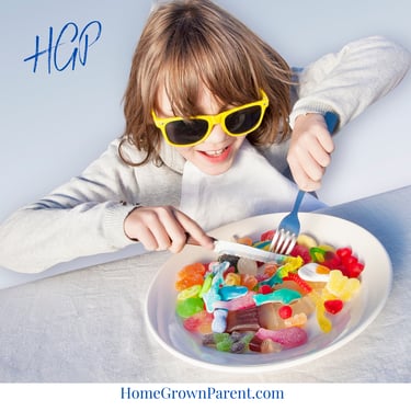 girl eating candy on a plate with a knife and fork