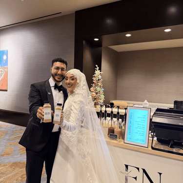 Bride and groom with personalized his and hers bottled lattes at Friday Coffee wedding cart