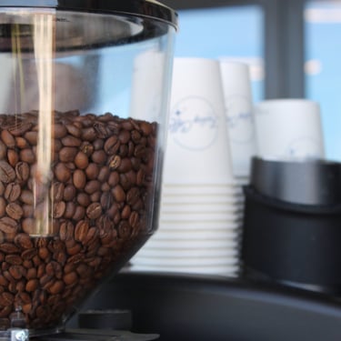 Professional espresso machine and grinder with branded cups at Dallas mobile coffee cart catering 