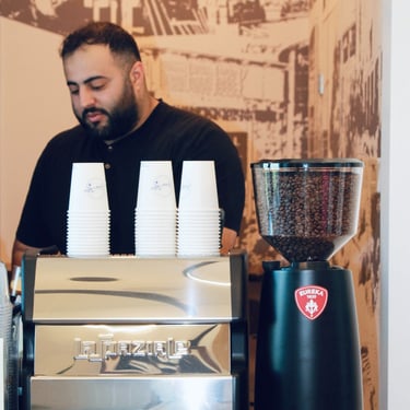 Professional barista preparing espresso drinks for Friday Coffee Cart