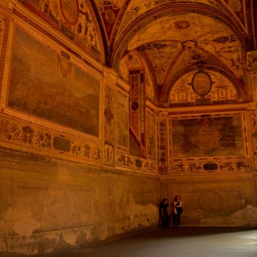 A photo of two young people in a corner of a beautiful old building, admiring it