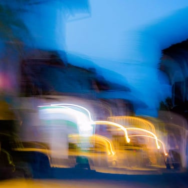 A colour photograph of blurred street lights