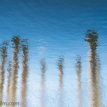 A colour photograph featuring abstract objects’ reflection in the water