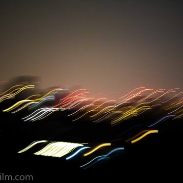A photograph of blurred multicoloured city lights