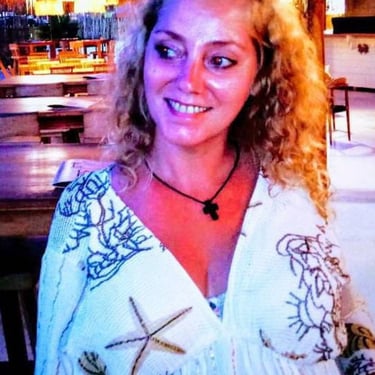 a woman in a white shirt and a glass of wine