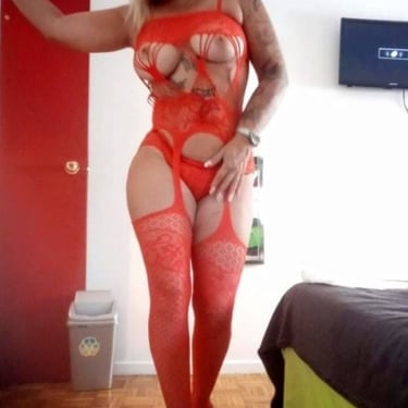 a woman in a red lingersuit posing for a photo