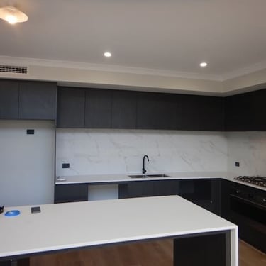 Inspector performing PCI inspection Perth before new home handover, assessing wall finishes and door fittings.