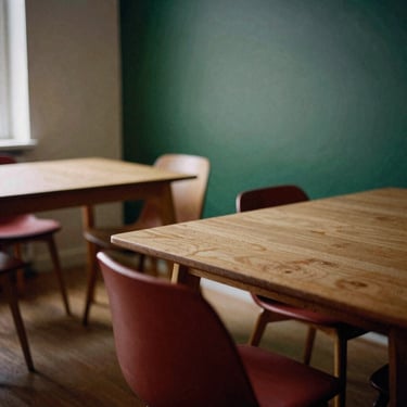 Cozy Scandinavian dining room interior, soft natural daylight, minimalist wooden tables, matte texture