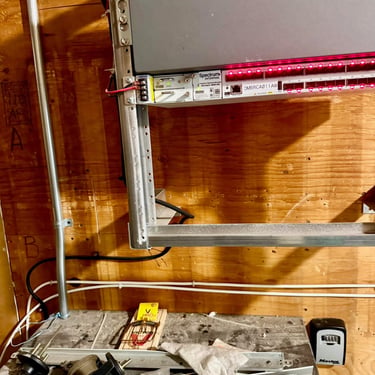 Exterminator on a commercial rodent control service inside an equipment room in Riverside, CA Footprint Pest Management