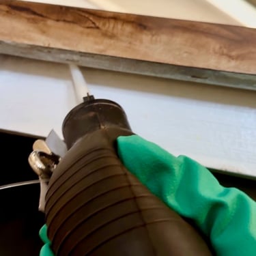 Exterminator on a German roach treatment crack and crevice application in Menifee CA
