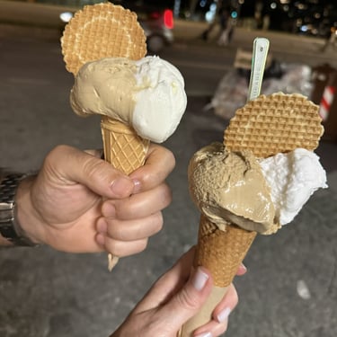 Coffee and coconut gelato cones with wafers being held on our Italy trip