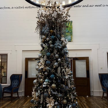 Tall holiday Christmas tree inside a Villages Fenney recreation center decorated to match the center’s theme