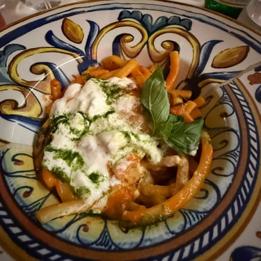 Pasta served in a colorful dish at an Italian restaurant