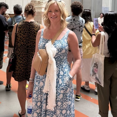 White shrug displayed off the body to show its thin fabric for warm weather layering