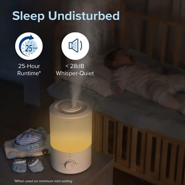 Levoit humidifier misting quietly on nightstand beside sleeping baby in crib
