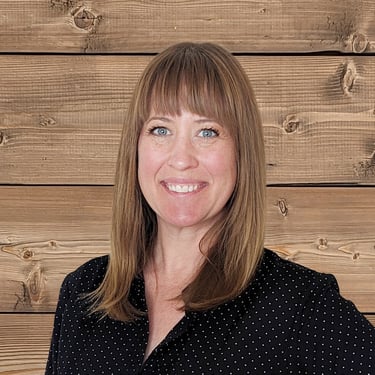 a woman with blue eyes and a black shirt