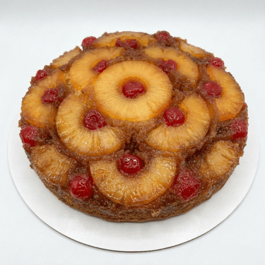 Golden rum bundt cake topped with pineapple rings and cherries