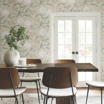 Modern dining room featuring floral wallpaper, a wood table, and mid-century chairs by French doors.