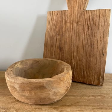 a wooden bowl with a wooden cutting board and a wooden cutting board