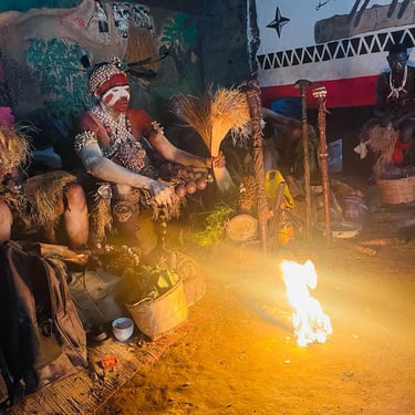 a group of people sitting around a fire. Bwiti ceremony
