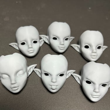Collection of BJD head prototypes printed with dental-grade precision for smooth face-ups
