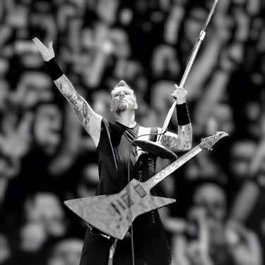 a man with a guitar and a guitar in a stadium