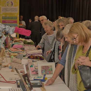Visitors to The Sandy Garden Show admiring some of the handicraft exhibits