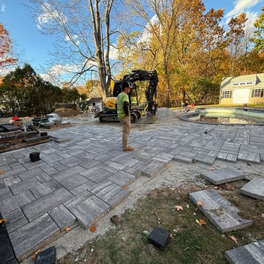 patio being installed around a pool by Capstone Landscape Services