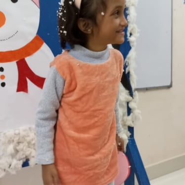 Children smiling while engaged in art activities.