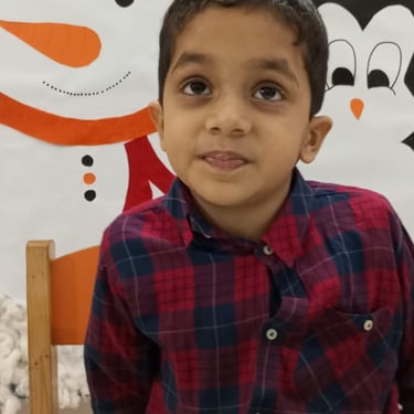 Child exploring sensory play with therapist's help