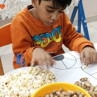 Child experimenting with sensory materials in therapy