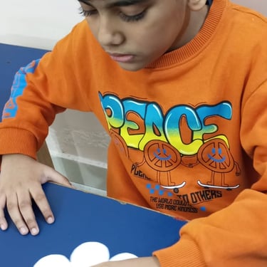 Child experimenting with sensory materials in therapy