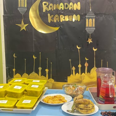 "Variety of colorful cupcakes with frosting, arranged on a decorative stand at a celebration."