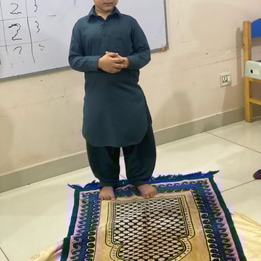 "Delicious chocolate cake topped with fresh fruit, served on a white plate against a rustic wooden background."