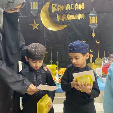 "Elegant table setting with white plates, cutlery, and decorative floral arrangements on a tablecloth."