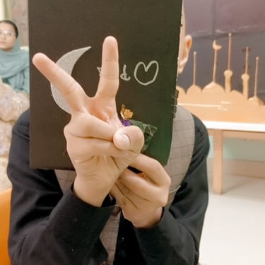 Kids showcasing their artwork in a group.