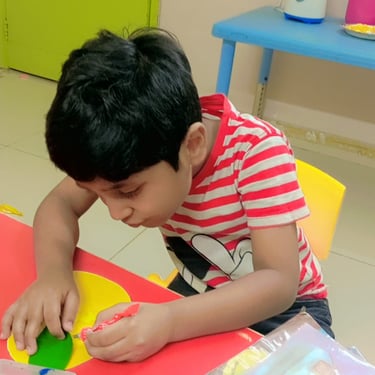 Child exploring colorful materials in therapy