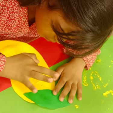 Child smiling while playing with therapy toys