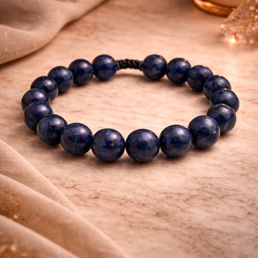 8mm lapis lazuli bracelet deep blue natural stone with gold flecks on marble warm light