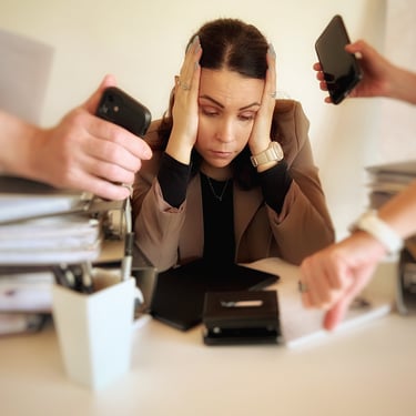a woman sitting at a desk with her hands on her head, four hands show her watches,she seems stressed