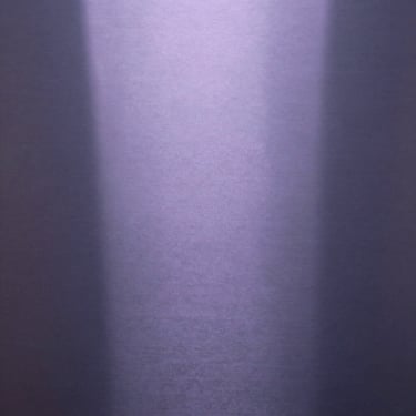 Abstract play of soft lavender light reflecting off a brushed steel surface, quiet minimalist composition.