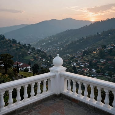 Historic estate balcony in Mussoorie overlooking the sprawling Doon Valley at dusk.