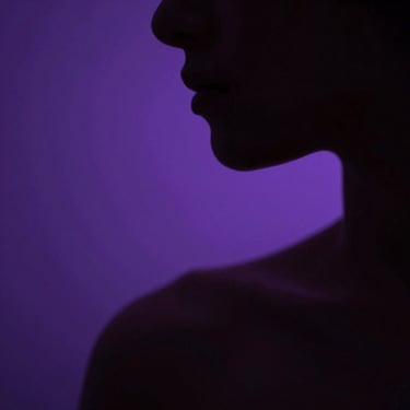 Extreme close-up of a human silhouette's shoulder and jaw in sharp rim-light, deep violet haze behind, high-contrast shadow consuming most of the frame, cinematic depth of field