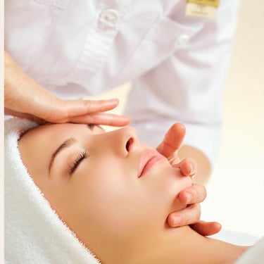 A woman receiving a professional facial massage at a luxury skin care spa center.