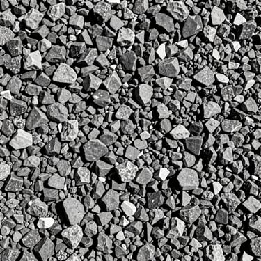 Close-up of crushed gravel of different sizes, sharp mineral edges, high-contrast industrial photography, 35mm