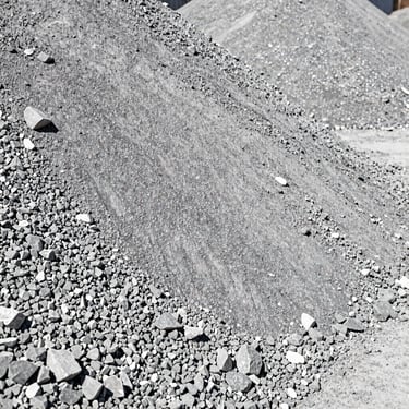 Industrial pile of crushed limestone and ballast, sharp stone textures, harsh direct sunlight, professional photography