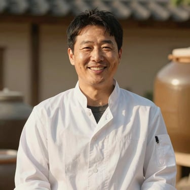 Professional portrait of a Korean master fermenter, smiling warmly, wearing a clean white chef coat, warm natural lighting, soft background