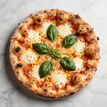 Overhead 45-degree angle of a freshly baked pizza margherita with bubbling mozzarella and basil on a marble surface, bright daylight