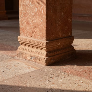 Close-up of a hand-carved Jaisalmer sandstone joint meeting a smooth terrazzo floor, soft warm side lighting highlighting the raw stone texture, architectural detail photography